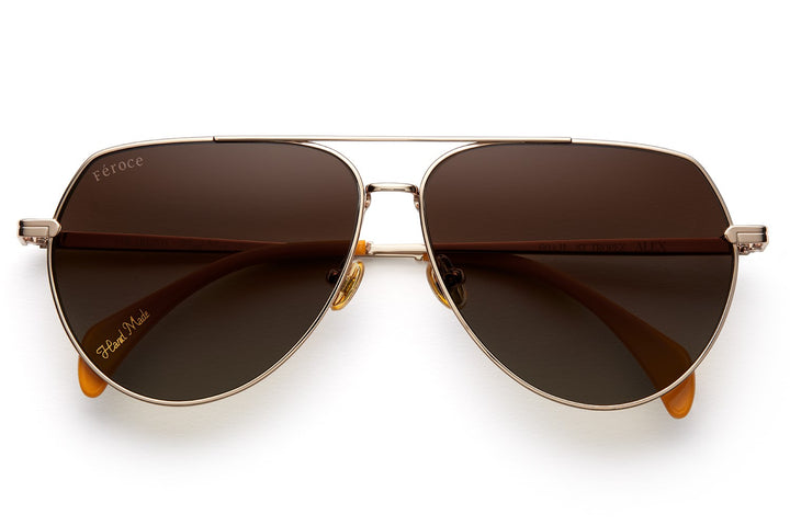 Gold titanium sunglasses with gradient brown lenses and gold tone hardware