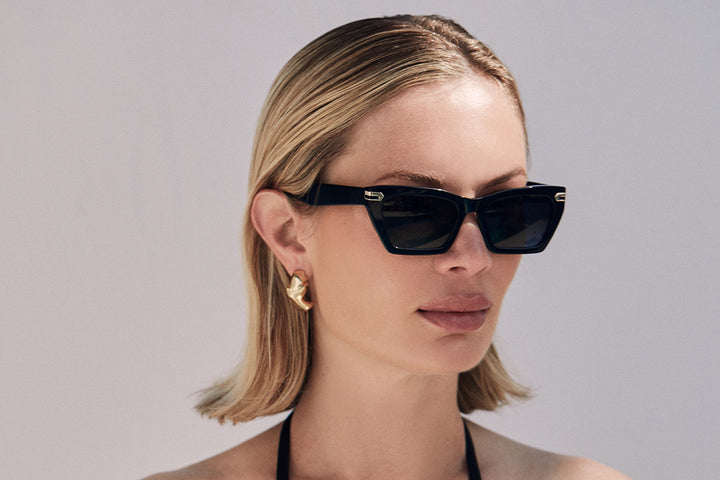 Black acetate sunglasses with dark grey lenses and gold tone hardware