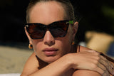 Speckle acetate sunglasses with dark brown lenses and gold tone hardware
